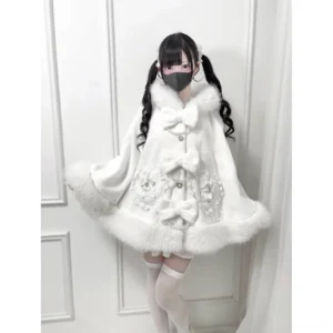 White faux fur Jirai Kei winter cape with floral embroidery and bow accents, front full body view on model