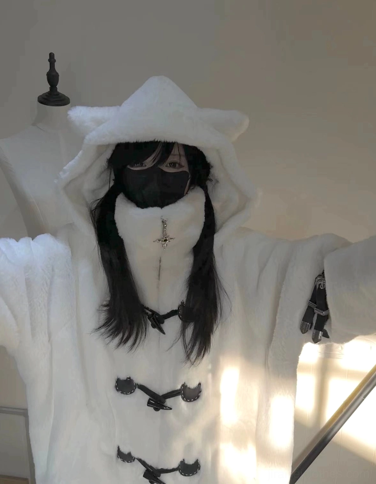 White fuzzy cat ear hooded coat full front view indoor display area loose fit horn toggles cross pendant ornament