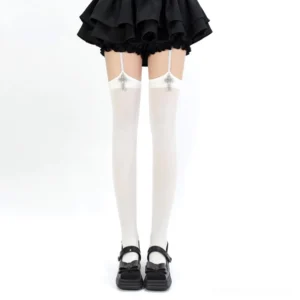 Pure white Gothic cross pendant Jirai Kei garter thigh-high stockings with silver cross pendants displayed on model in black ruffle skirt front view aesthetic