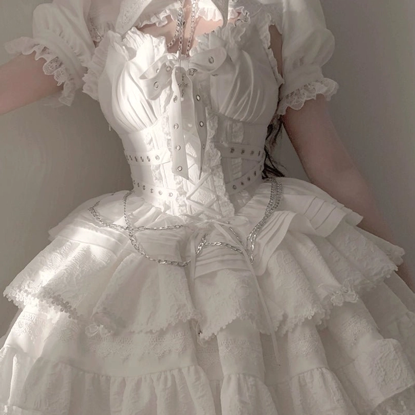 White Gothic Lolita dress close-up waist-down detail showing lace-trimmed puff sleeves corset waist metal chain decorations