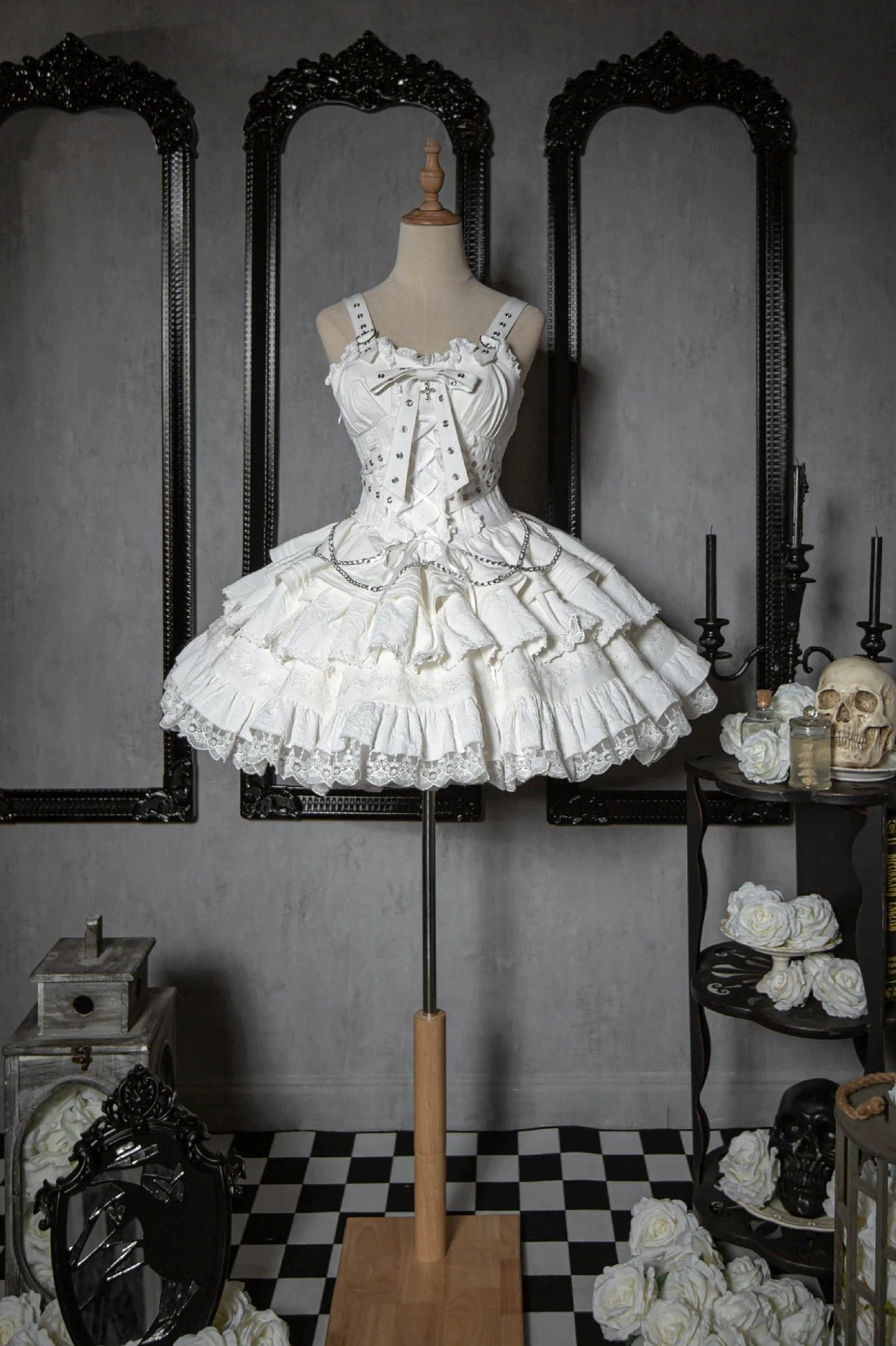 White Gothic Lolita jumper dress front flat display view featuring lace frills multi-layered tutu skirt vintage gothic interior background
