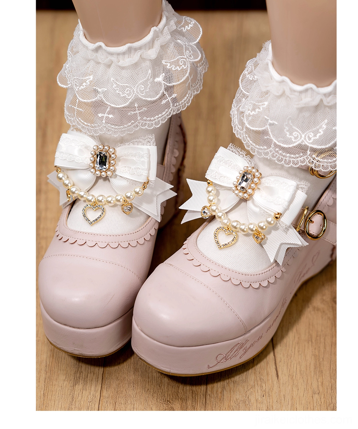 White bow shoe clips pair for Jirai Kei fashion displayed on mannequin feet with pink Mary Janes and delicate lace socks