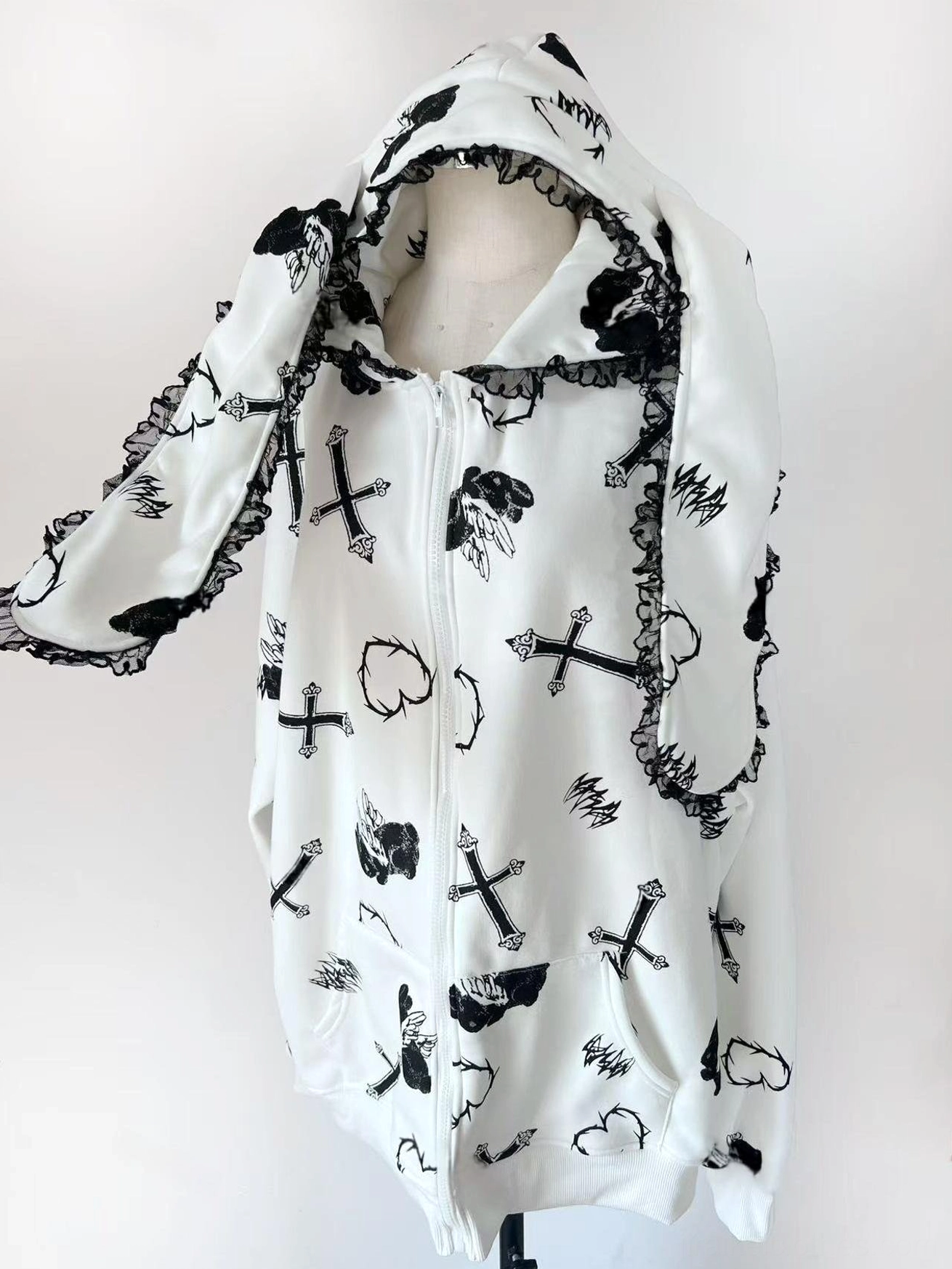 White Jirai Kei bunny ear hoodie coat front product view with lace-trimmed bunny ears, cross and heart anime prints, and oversized fit silhouette