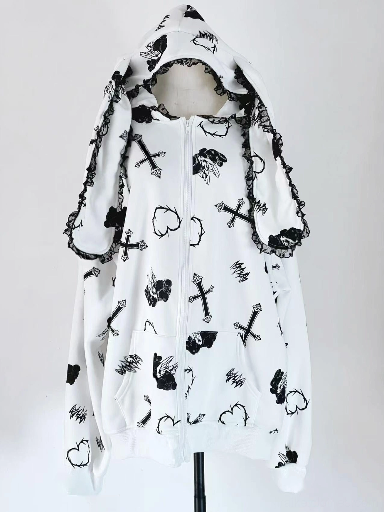 White Jirai Kei bunny ear hoodie coat with fleece lining, showcasing lace-trimmed hood detail, cross and heart pattern prints, and warm cozy interior