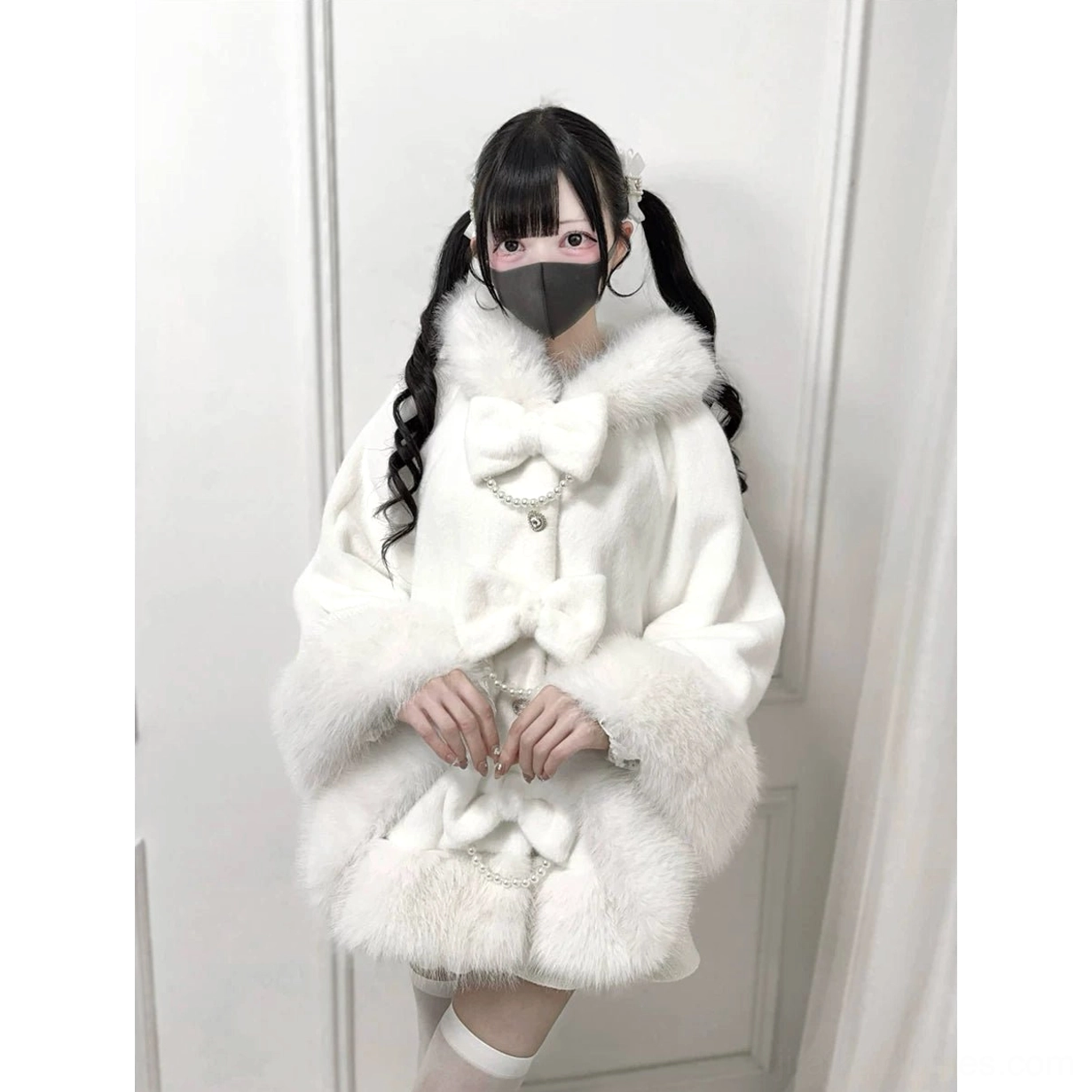 White faux fur Jirai Kei cape close-up front view showing pearl chain embellishments and bow decorations