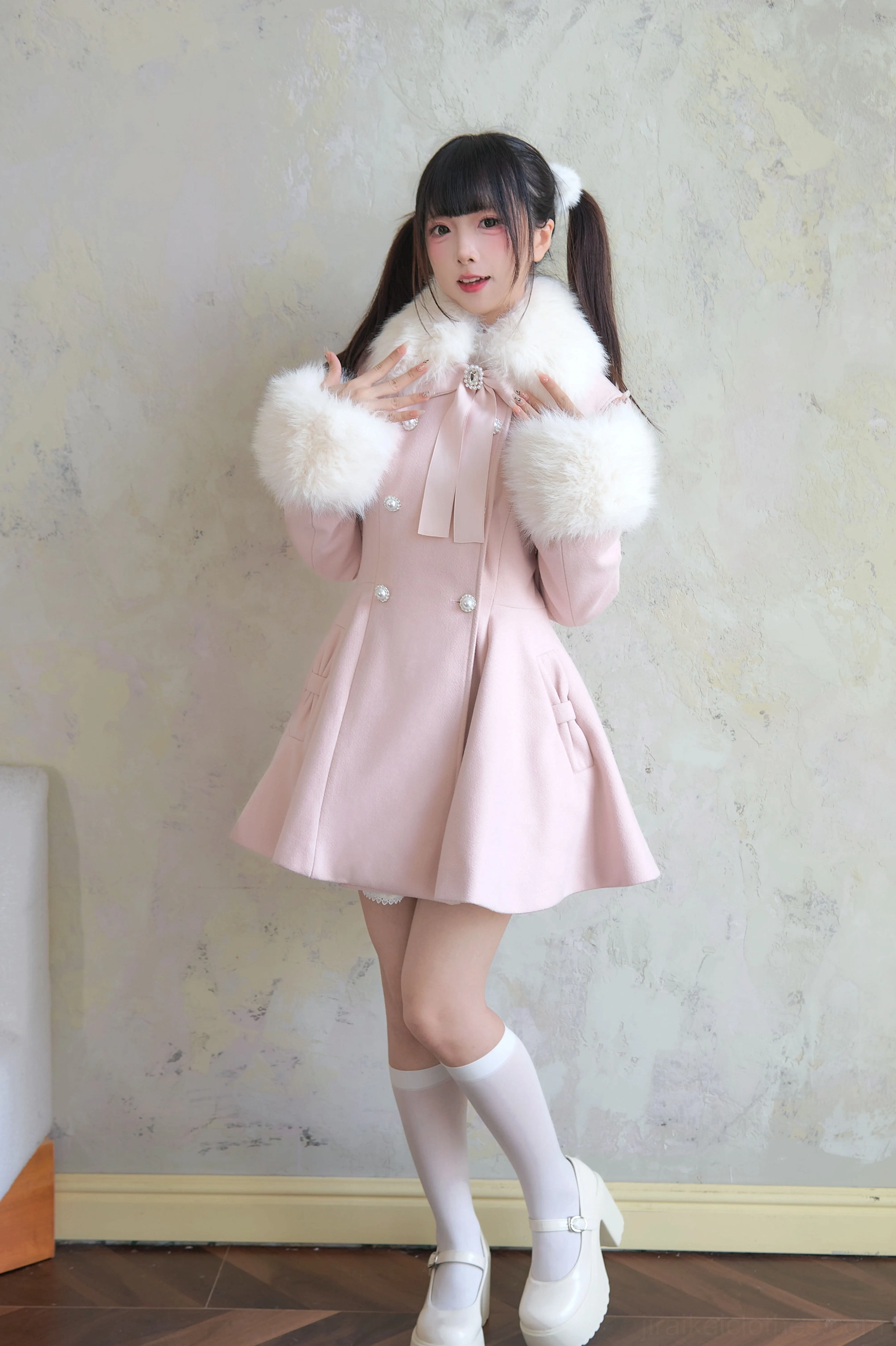 Close-up white Jirai Kei winter coat front view featuring neck bow decoration fluffy faux fur trim platform shoes and lace stockings