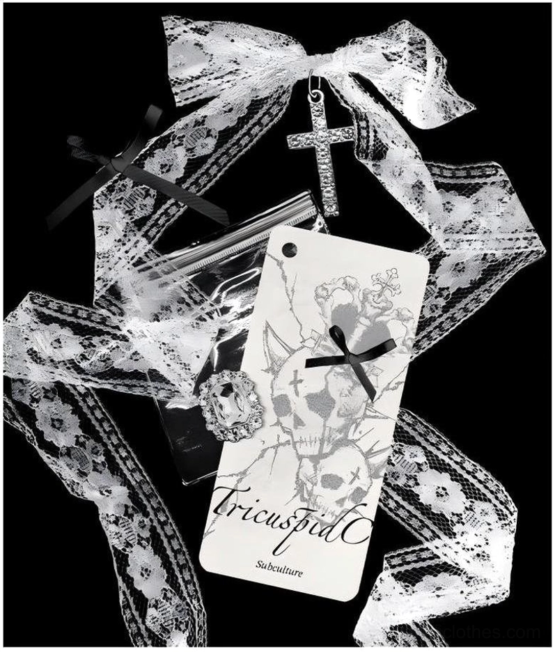 White cold-shoulder jirai kei oversized t-shirt with dual skulls print and cross strap details close-up