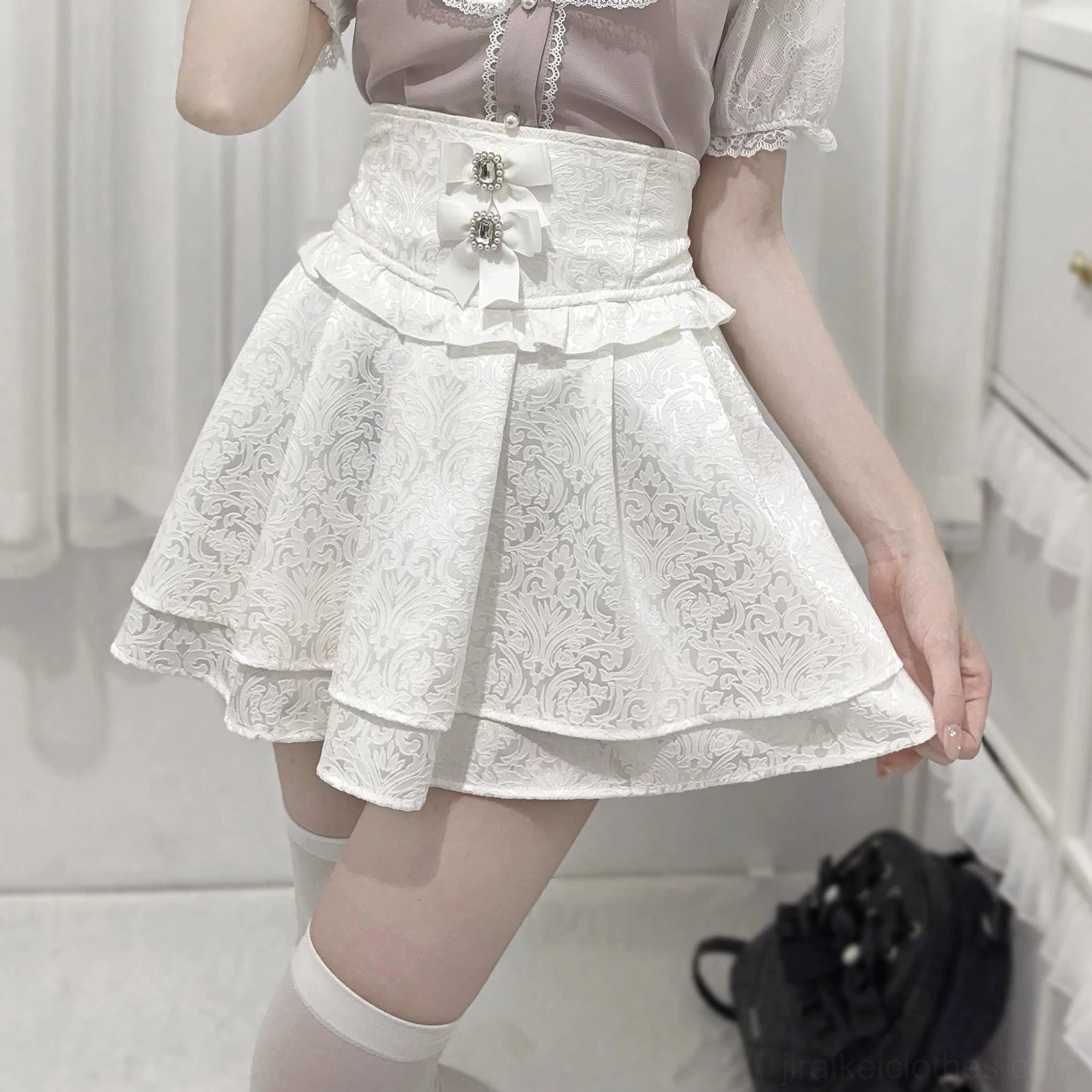White Jirai Kei double-layer ruffled skirt high-waist jacquard texture bow waist detail front view