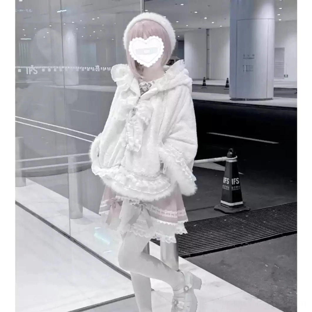 Three-quarter back angle of white jirai kei fleece cape coat with cat ear hood showing silhouette, ruffle hem, and construction quality