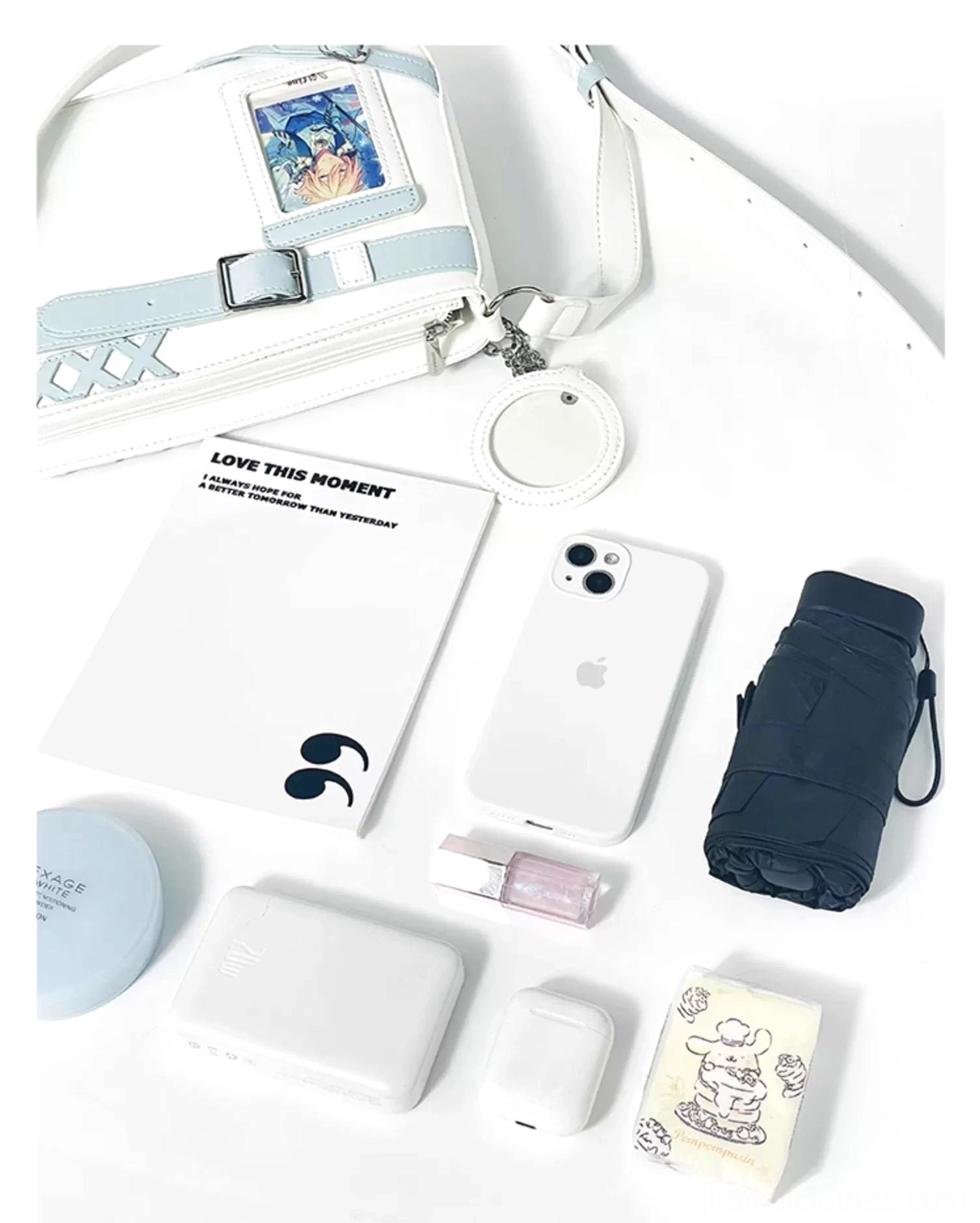 White Jirai Kei ita bag flat lay with anime card display and personal accessories like phone showing practical functionality