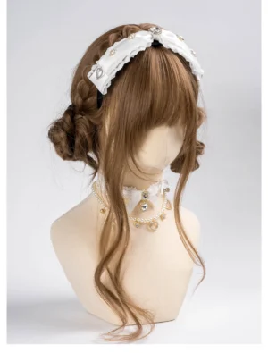 White Jirai Kei lace bow rhinestone headband with heart charms, front view on mannequin, ruffled lace trim and gold-plated gems