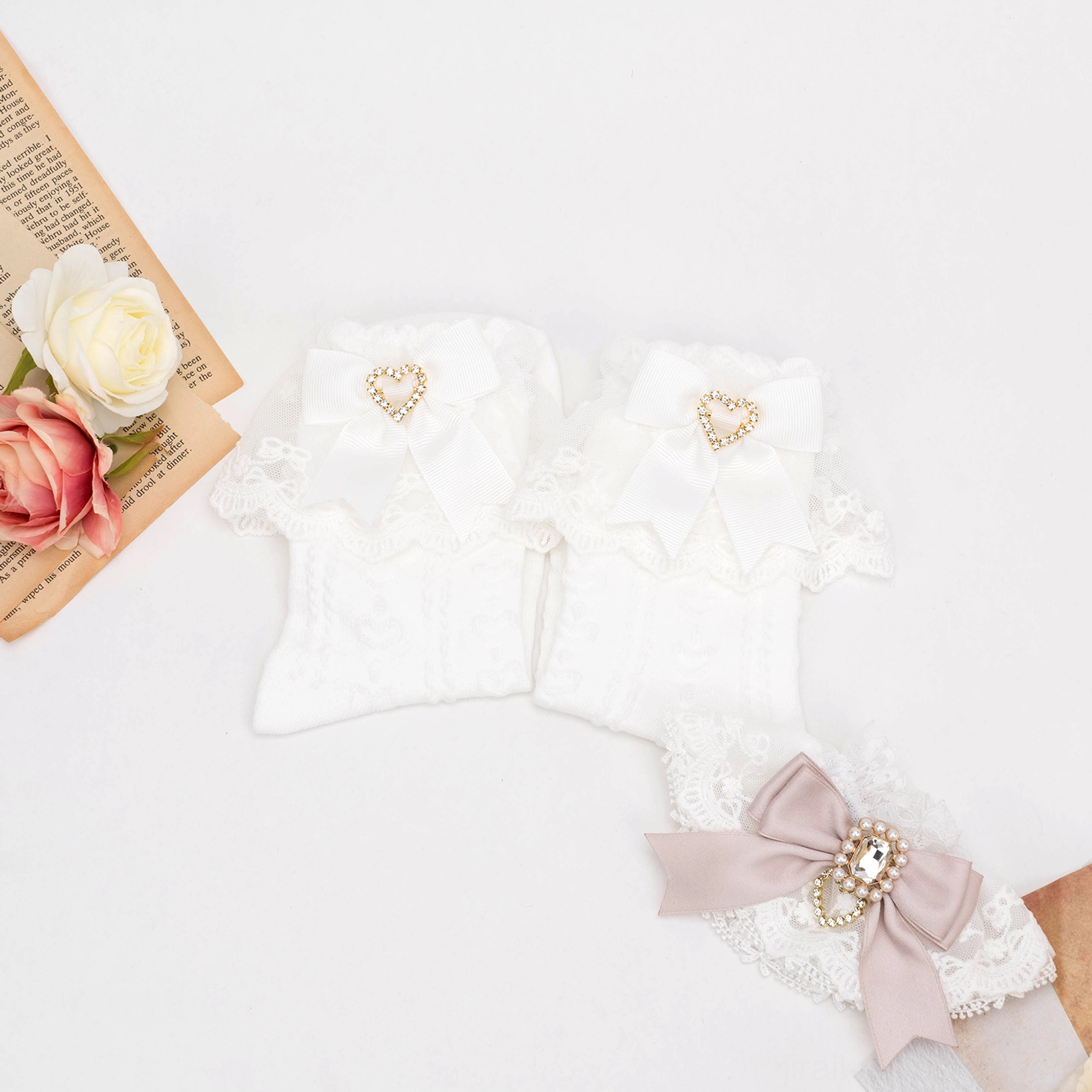 White frill Jirai Kei lace socks with cable-knit texture and heart rhinestone bow decoration flat lay aesthetic styling