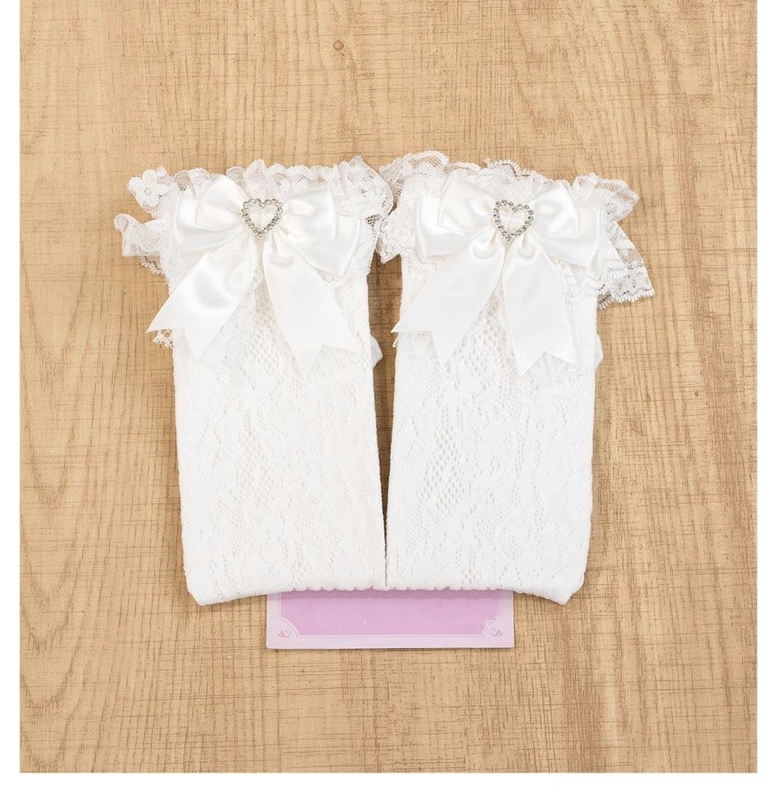 White jirai kei lace ankle socks with heart-shaped rhinestones and decorative satin bow details in pure color
