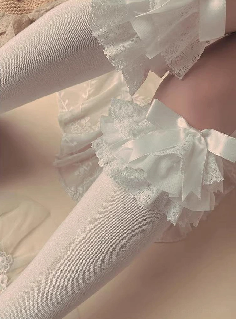 White Jirai Kei lace bow sock cuffs with large layered lace bow accents soft fabric close-up overhead view detail shot