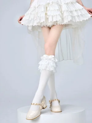 White Jirai Kei lolita calf socks featuring delicate ruffled lace trim cuff and solid knit texture on model wearing white tiered ruffled skirt