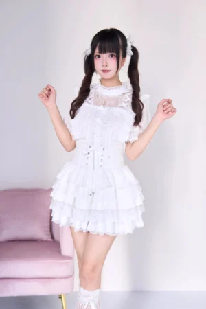 White gothic lolita jirai kei two-piece set with pearl necklace blouse and tiered cake skirt, front full-body view showing lace collar corset waist and layered ruffles