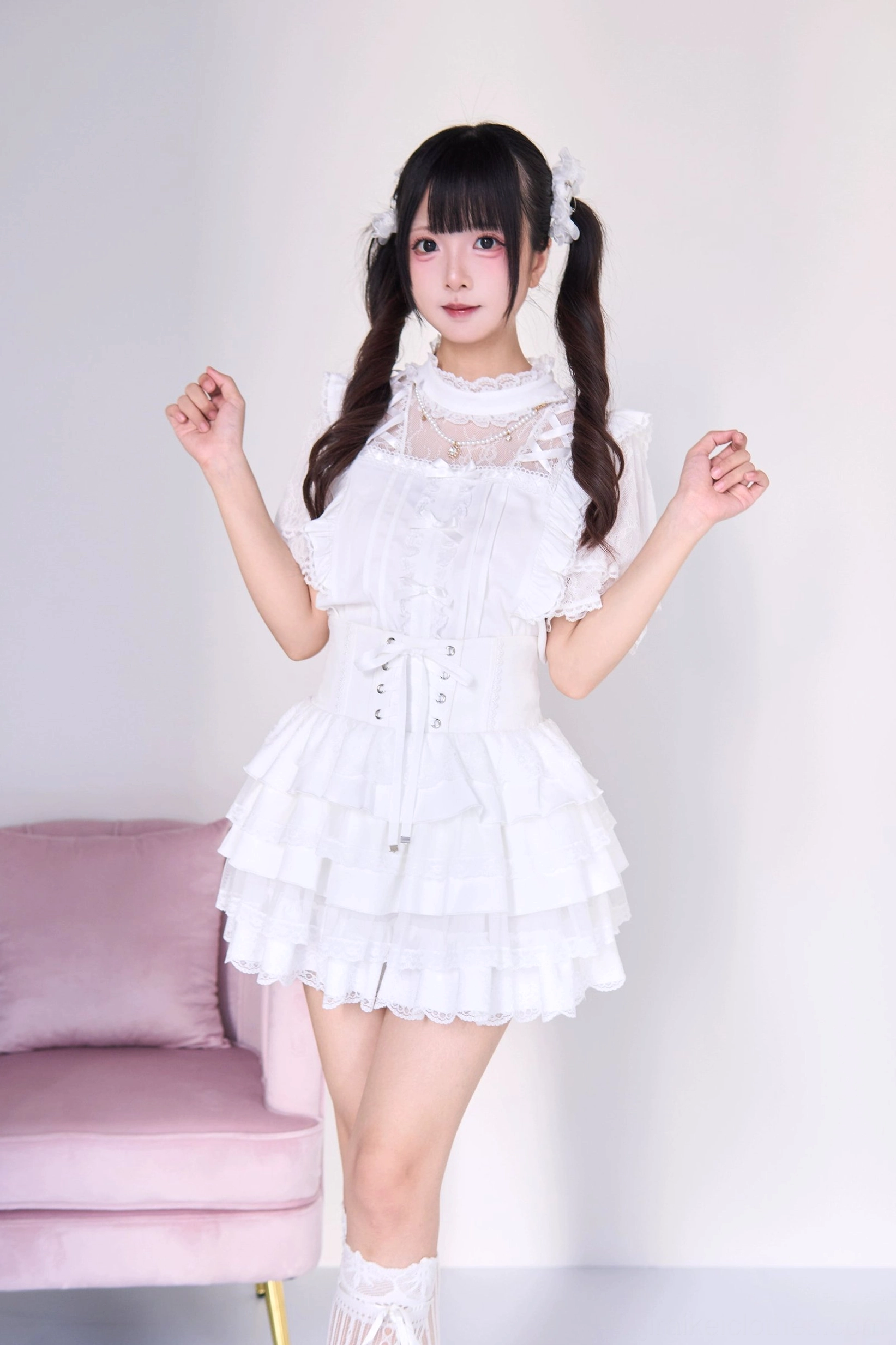White gothic lolita jirai kei two-piece set with pearl necklace blouse and tiered cake skirt, front full-body view showing lace collar corset waist and layered ruffles