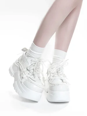 White Jirai Kei high platform shoes low side view of wearing feet with lace-trimmed upper lace-up closure and chunky platform sole
