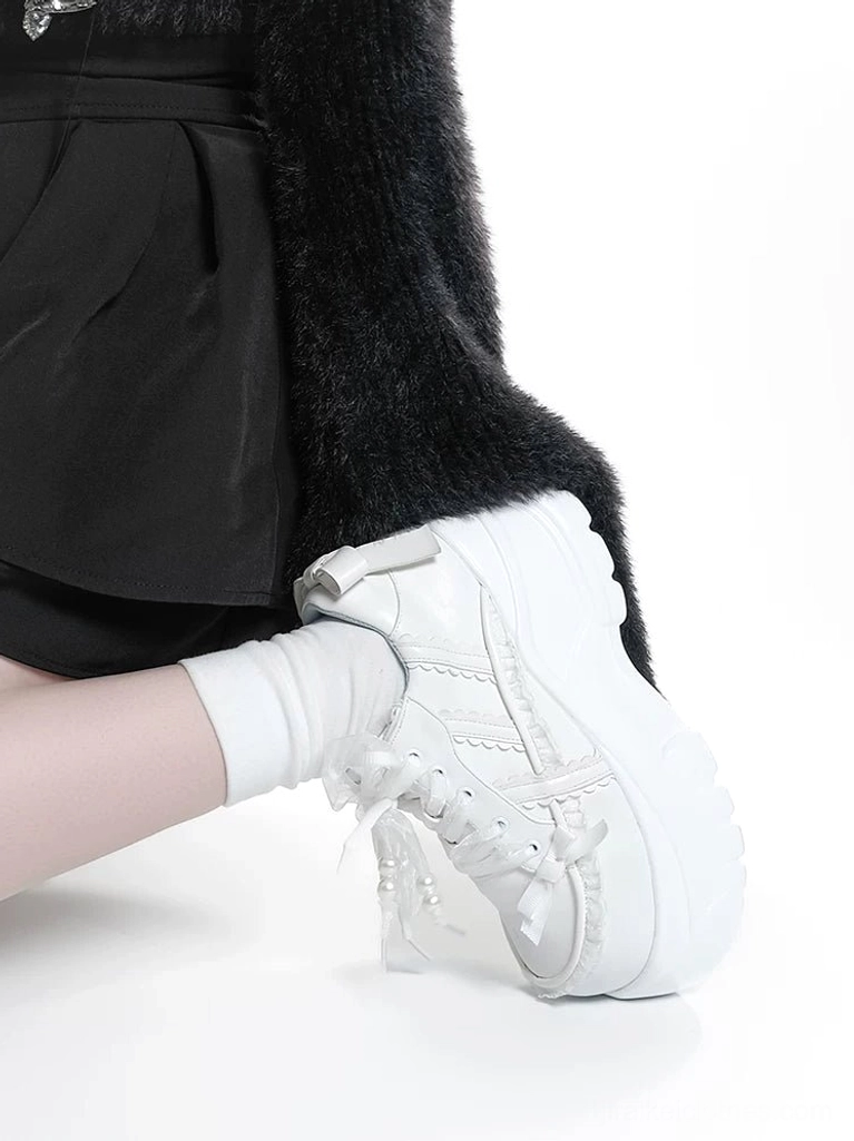 White Jirai Kei platform sneakers side close-up view of wearing shoe with sheer lace bow trim pure white upper and chunky platform heel