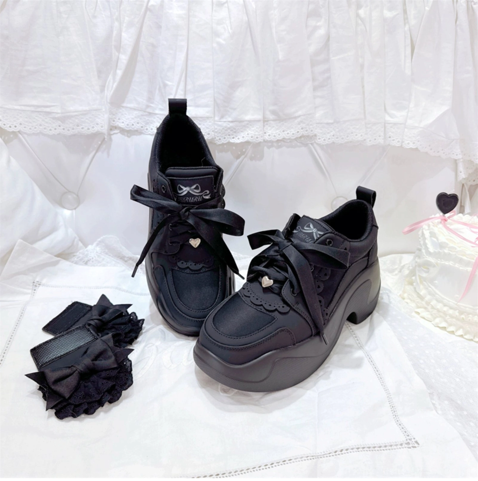 White Jirai Kei platform sneakers low angle foot view pristine white chunky platform lace bow ruffle accents clean studio background