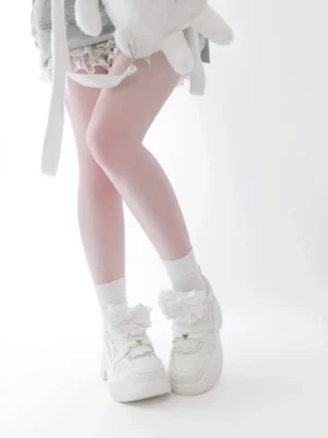 White Jirai Kei platform sneakers with ruffle trim direct front foot view chunky platform sole bow accents studio background