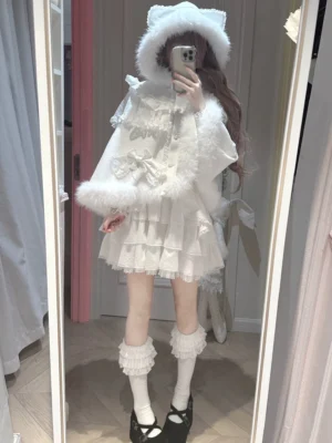White Jirai Kei winter ensemble complete three-piece set featuring sailor blouse high-waist skirt and cat-ear hooded cape with fluffy fur trim shown in full-body mirror selfie with tiered ruffled skirt and bow ornaments