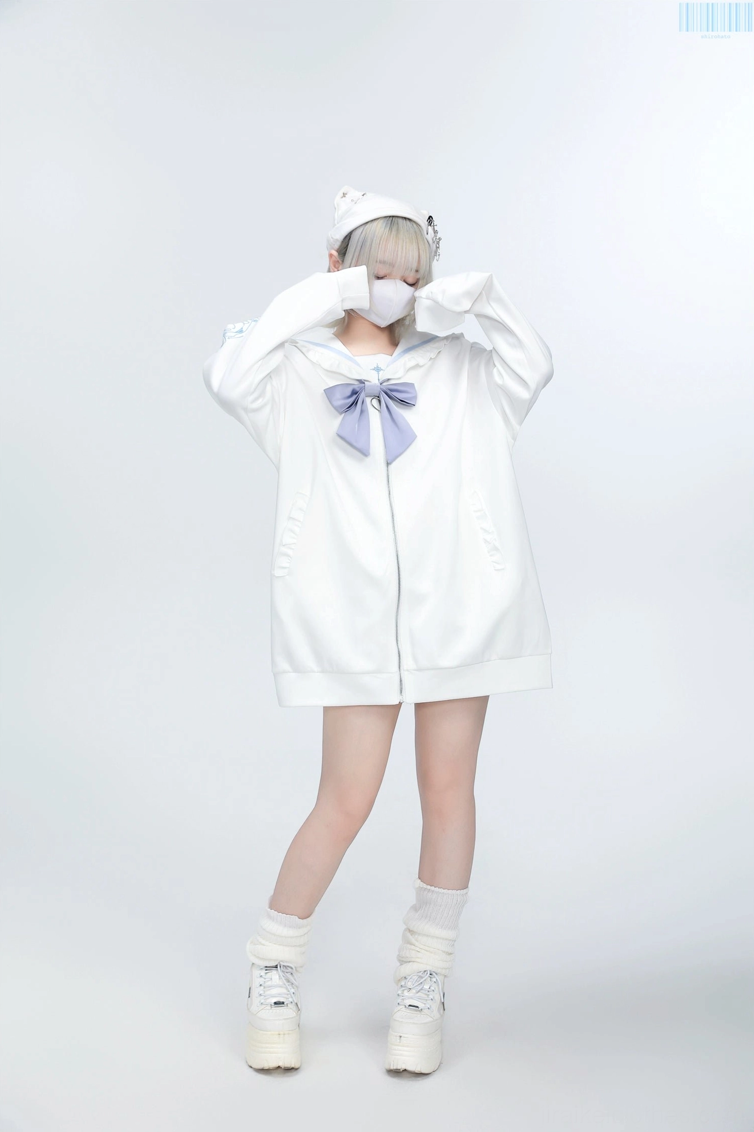 White Jirai Kei sailor jacket light purple embroidery and bow, model's hands raised showing full jacket silhouette