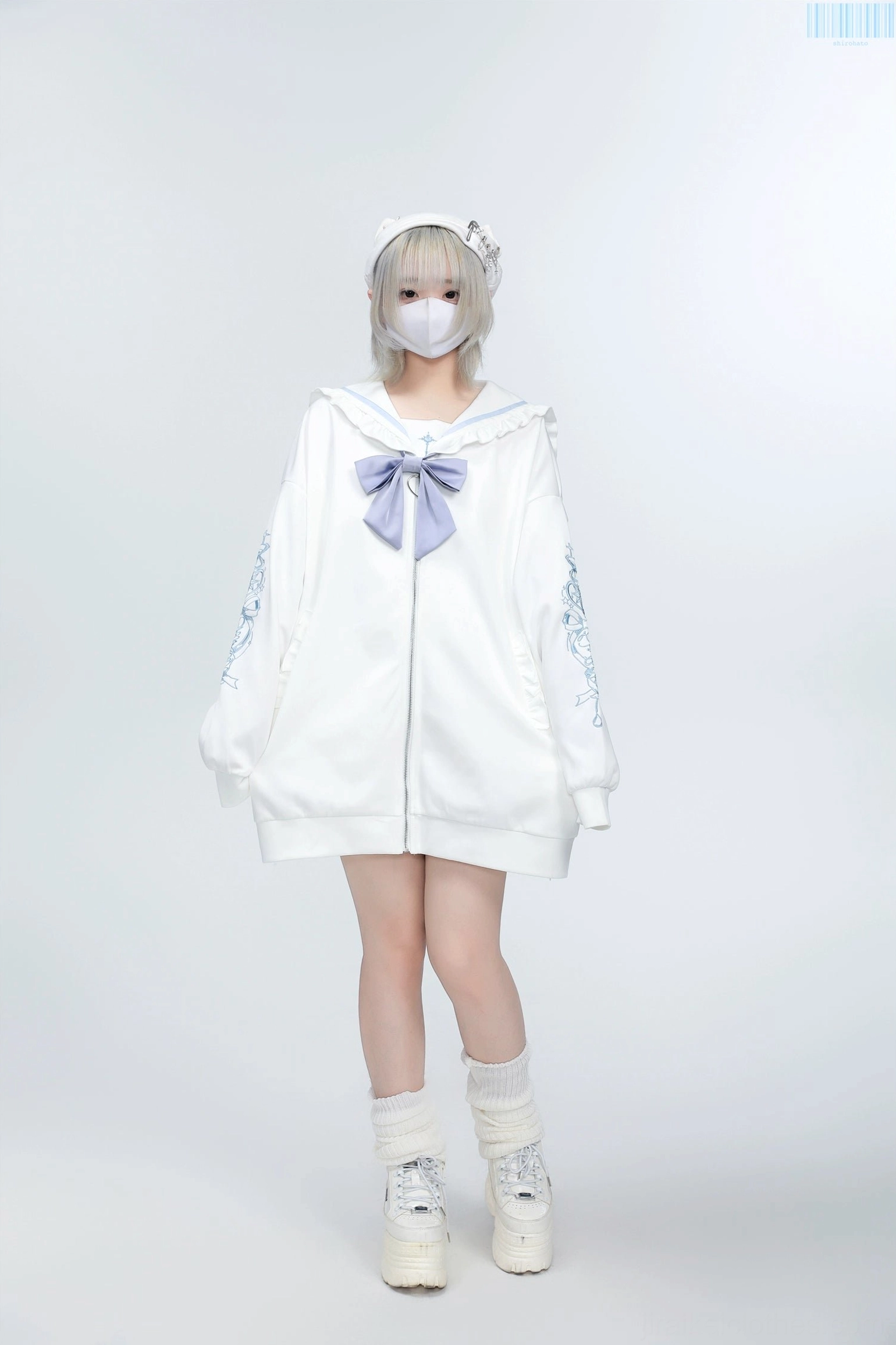 White Jirai Kei sailor collar embroidered zip jacket with light purple bow and sleeve embroidery, worn by light gray-haired model in studio