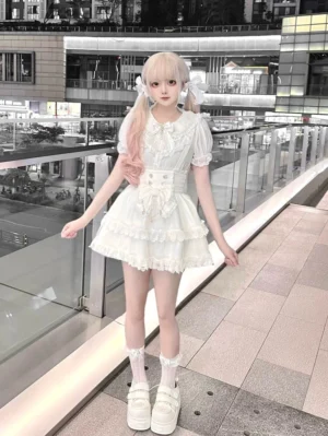 White sweet lolita blouse and suspender skirt set full-body front view with twin-tailed model wearing puffed sleeves, lace trim details, and high-waisted corset waist construction