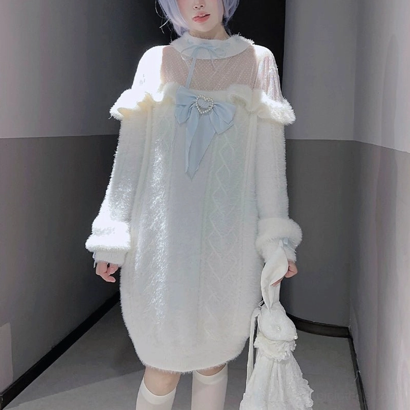 Close-up front view detail of white plush velvet sweater with ruffled off-shoulder trim, cable knit texture, and gem-studded light blue bow