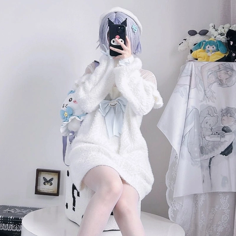 Half-body front sitting view of fluffy white plush sweater with large front bow accent, model wearing light purple beret