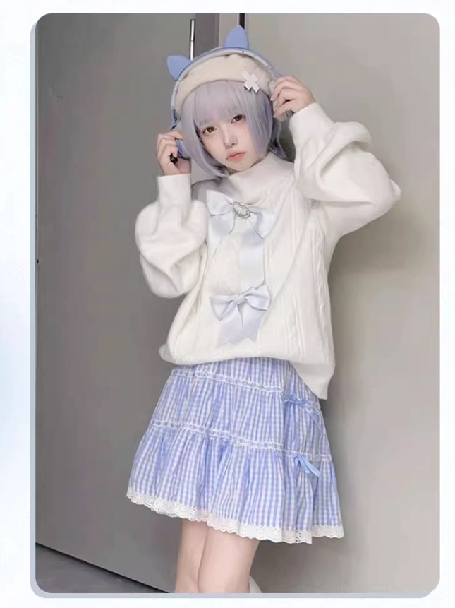 Sleeve detail of white Jirai Kei sweater showing tulle paneling, ruffle trim, and detachable bow accent placement
