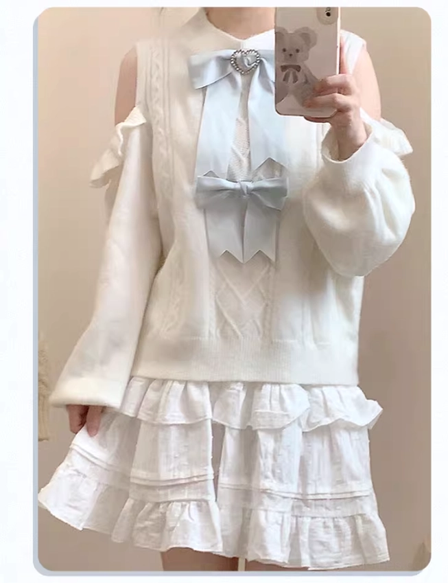 Close-up detail of tulle paneling and ruffle trim on white Jirai Kei sweater showing sheer construction technique