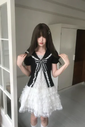 White tiered ruffle Jirai Kei skirt with elastic waistband shown on long-haired model in indoor hallway setting