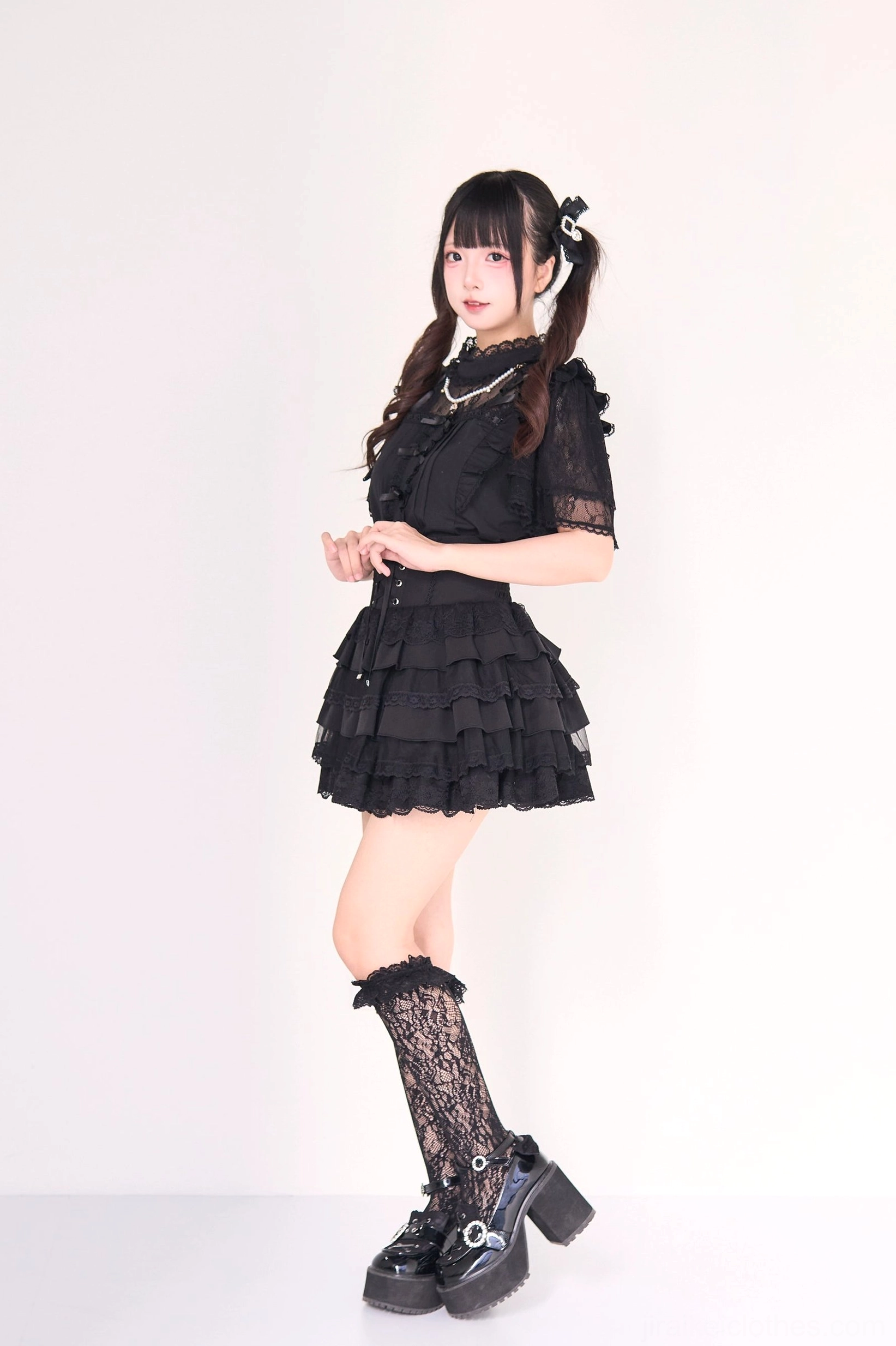 White jirai kei tiered cake skirt lace hem trim detail and ruffle layering close-up showing romantic gothic lolita aesthetic construction quality