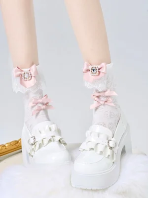 White Jirai Kei ankle socks featuring light pink rhinestone bow and delicate lace cuff, paired with white platform loafers for complete outfit