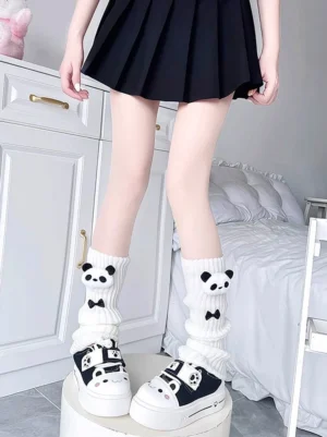 White panda plush decorated JK leg warmers with black bow accents worn with pleated school skirt and platform shoes, Jirai Kei style leg warmer low front view bedroom vanity