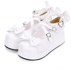 White pearl luster Jirai Kei platform Mary Jane shoes featuring lace-trimmed cross-buckle ankle strap heart-shaped metal buckle ornamental bow decorations and thick foam sole flat lay front view