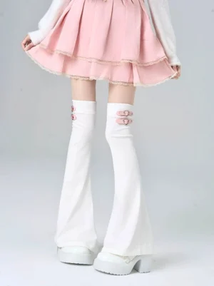 white y2k jirai kei flared leg warmers with pink heart-shaped buckle decorations over-the-knee silhouette paired with pink ruffled pleated skirt and white platform shoes front view