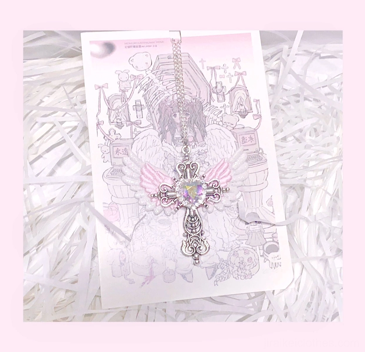 White and pink Jirai Kei winged cross necklace with pink heart gem and silver filigree cross on pink border art card white filler