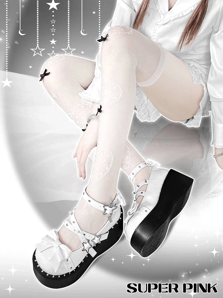 White platform Mary Jane shoes on model's legs in thigh-high star stockings and white loungewear, side angle view showing chunky platform sole and dual ankle straps