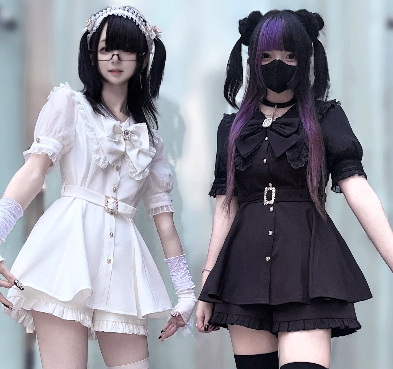 White puff sleeve and black short sleeve Jirai Kei lolita two-piece sets with matching big bow waist belt standing front view