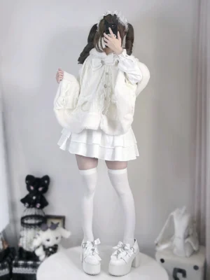 Front view of white rabbit ear fleece hooded cape coat worn by female model in studio, showcasing solid white plush fabric and front button closure with oversized loose fit