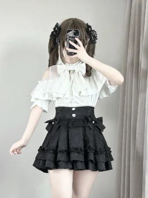 White off-shoulder ryousangata lace blouse with detachable bow worn with black ruffle skirt, front mirror selfie showing full jirai kei outfit styling