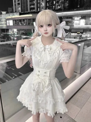 White Ryousangata suspender skirt with tiered tulle ruffles and detachable waist bow, front close-up view showcasing Peter Pan collar blouse and structured silhouette