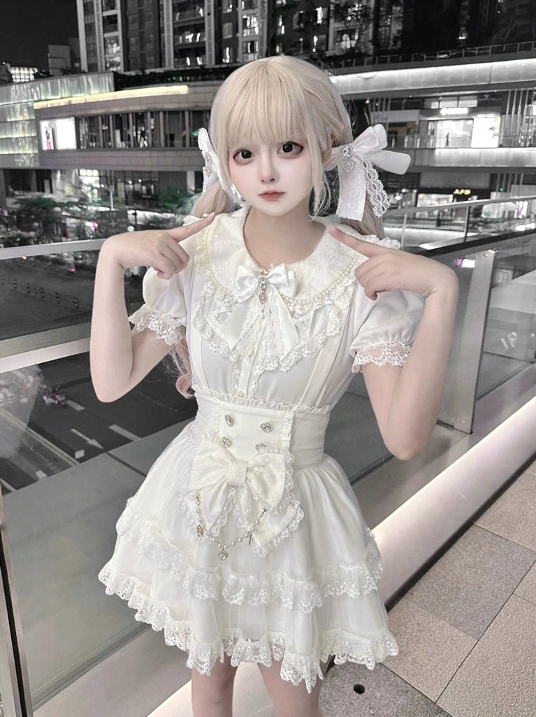 White Ryousangata suspender skirt with tiered tulle ruffles and detachable waist bow, front close-up view showcasing Peter Pan collar blouse and structured silhouette