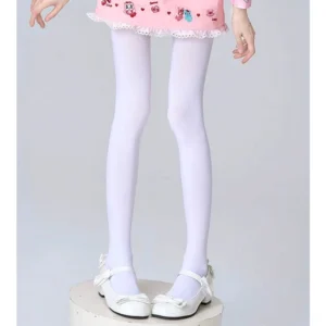 Solid white seamless opaque sheer pantyhose full lower body view on model wearing pink frilled skirt and white Mary Jane shoes plain studio background clean minimalist style