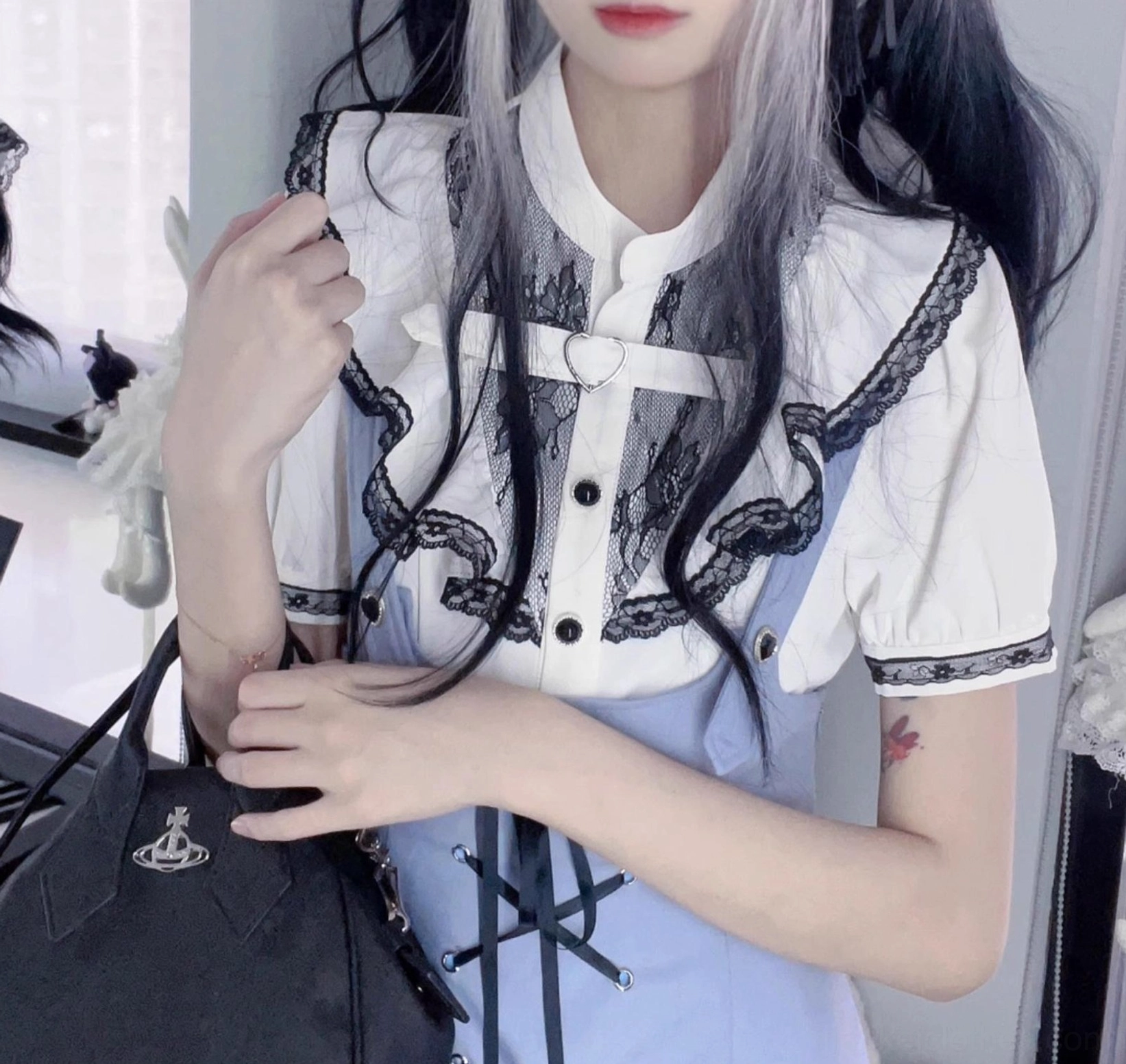 White short-sleeved jirai kei blouse with cross-shaped chest buckle lace ruffle and contrast cuffs