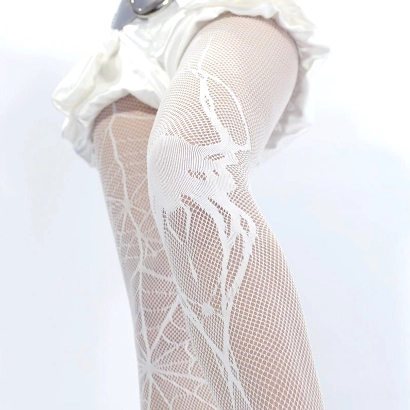White spiderweb fishnet tights side knee close-up detail large scale spider cobweb texture on mesh