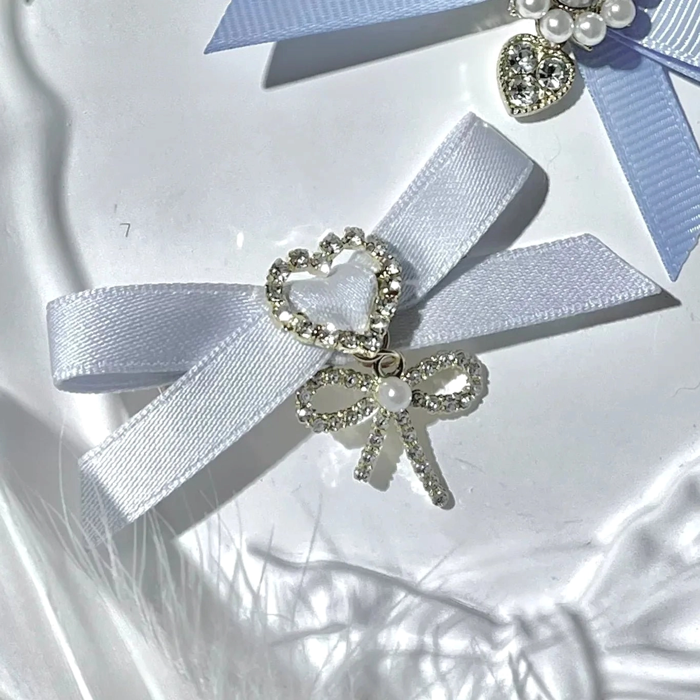 White swallowtail bow hair clips Jirai Kei aesthetic with rhinestone embellishment and heart pendant adorable cute style